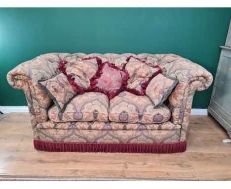 A  fine quality reproduction Chesterfield Settee by John Nethercott with Wm Morris style floral button upholstery, on bun fee