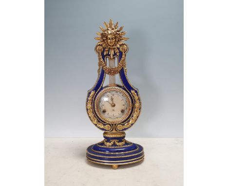 A Continental porcelain Mantel Clock with mask and lyre design and gilt metal mounts, 15 1/2in H 