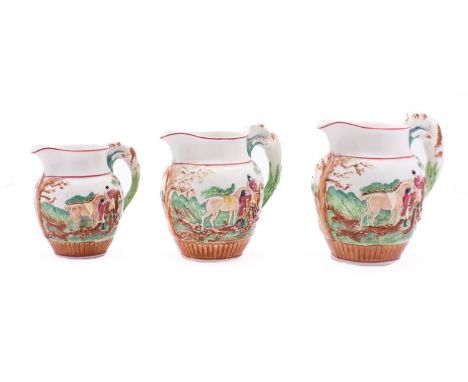 Three Wedgwood pottery 'hunting' jugs with moulded decoration and hound handles, impressed marks, tallest 13.5cm high.