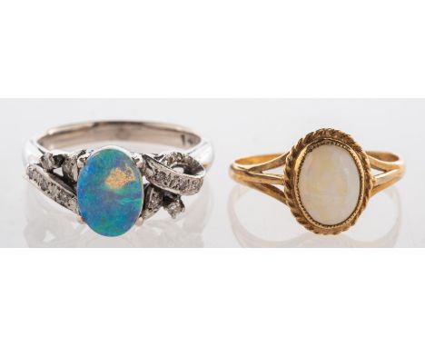 A group of two opal rings, one set with an opal cabochon and single-cut diamonds in a twist surround, marked 14k, K1/2 to L, 