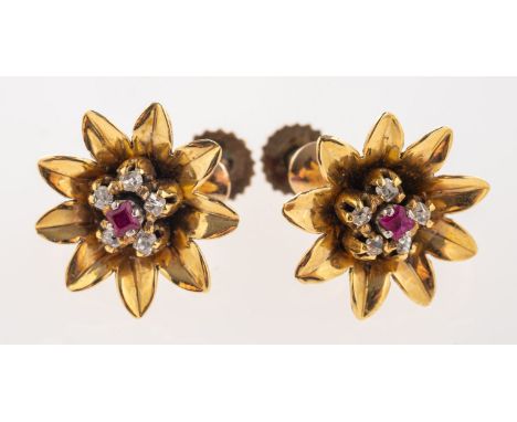 A pair of flowerhead screw back earrings, each set  with a table-cut ruby, surrounded by five old-cut diamonds, marked 9ct, d