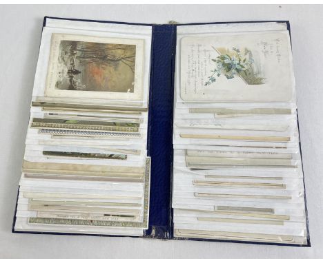 A blue album containing 47 assorted Edwardian &amp; vintage greetings cards. 