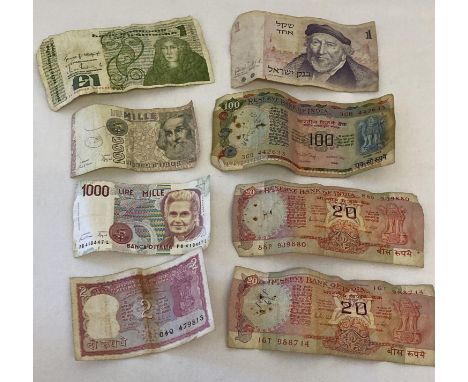 A collection of 8 vintage foreign bank notes from India, Israel, Ireland and Italy.