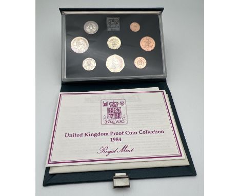 A cased set of 1984 Elizabeth II proof coins by Royal Mint. To include the Scottish Â£1 coin. Complete with information leafl