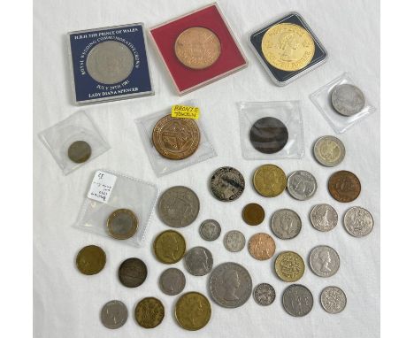 A collection of vintage British and foreign coins and medallions. To include an 1875 Victoria penny, 2 silver George V three 