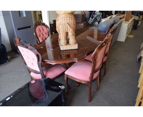 A reproduction dining table and six pink button back chairs