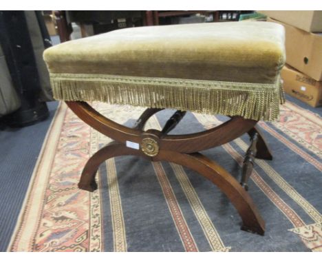 A mahogany X frame stool with gilt metal rosettes  