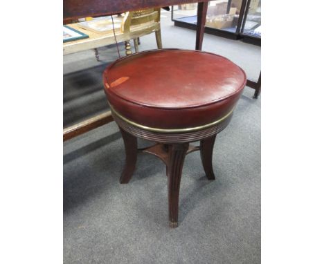 A Regency mahogany piano stool, with revolving height adjustable red leather seat  