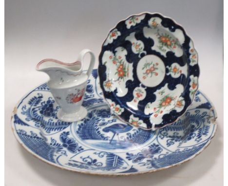 A New Hall cream jug, first period Worcester plate and a Delft blue and white dish  The Worcester and Delft have been glued t