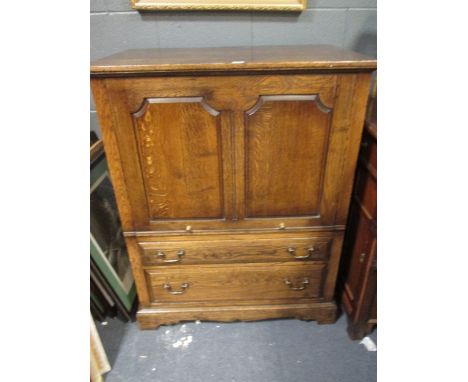 An oak television cabinet with drawers to the base, on bracket feet, 120 x 95 x 60cm  