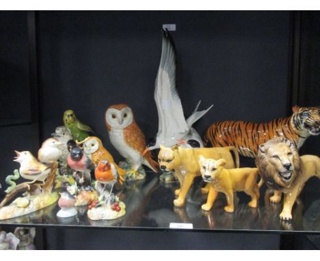 Nine ceramic bird figures or groups by Crown Derby, Beswick, Hutschenreuter and others, one tiger and three lions  