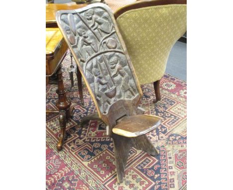 A tribal carved hardwood birthing stool  