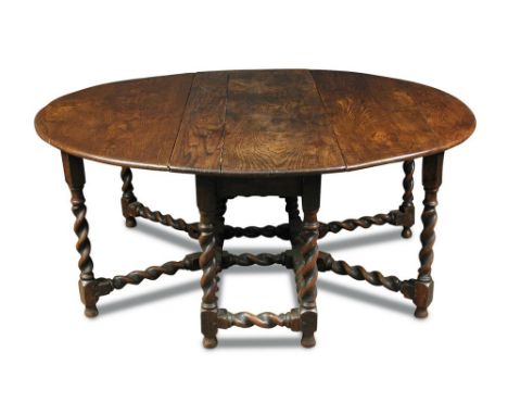 A 17th century and later oak gateleg table, on barleytwist legs with double gate action, on shaped feet 72 x 175 x 158cm (28 
