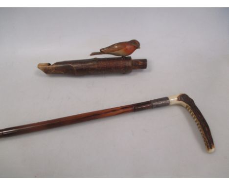 A child's silver mounted hunting crop and a bird whistle (2)  