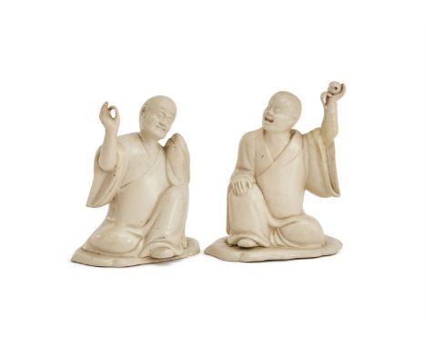 ‡&nbspA PAIR OF STAFFORDSHIRE WHITE SALT-GLAZED STONEWARE FIGURES OF LOHANS   CIRCA 1750  Each modelled after Fukien original