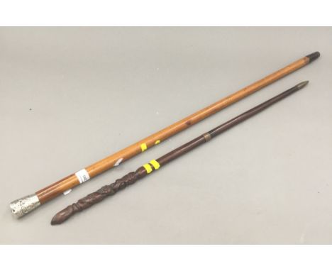 A Victorian malacca cane with Chinese silver top and an unusual  carved swagger stick with figural terminal