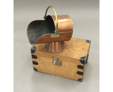 An iron bound trunk and a copper coal scuttle 