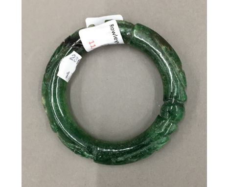 A carved jade bangle