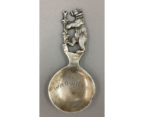 A silver souvenir spoon, Birmingham 1927, maker's mark for Bernard Instone, inscribed Warwick, and with dancing bear finial