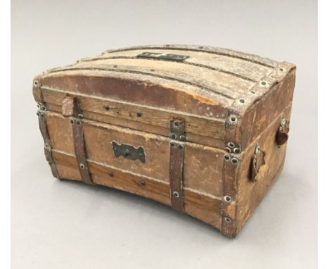 A 19th century French chocolate box formed as a miniature leather trunk 
