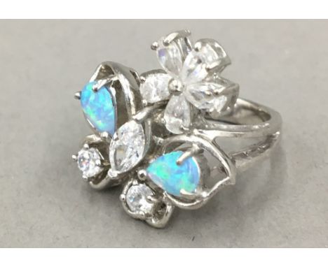 A silver cubic zirconia and opal ring