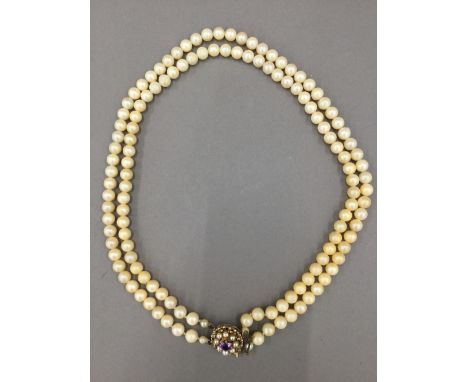A simulated pearl necklace with a 9 ct gold clasp 