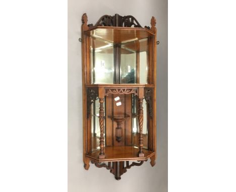 A Victorian walnut corner hanging display shelf