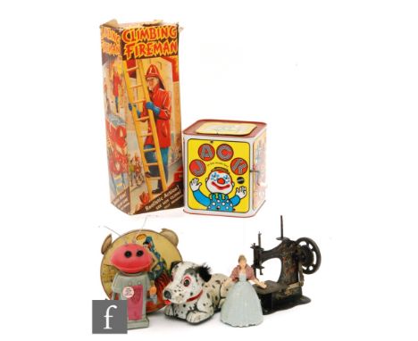 A collection of tinplate and plastic toys to include a Marx Mr. Smash, a boxed Marx Climbing Fireman, a Wells Brimtoy Fairy Q