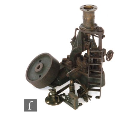 A 1930s cast iron steam engine with vertical oscillating piston, part disassembled, height 21cm