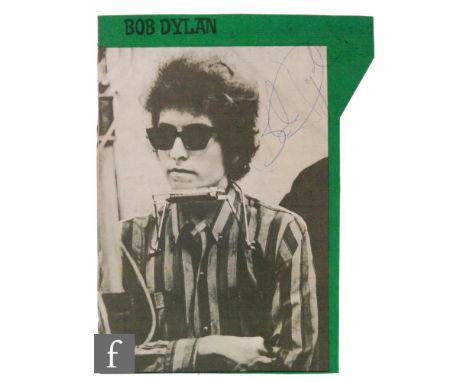 A signed Bob Dylan cutting, in blue ink, signed to the top right corner of a black and white magazine cutting, 23cm x 16cm.Pr