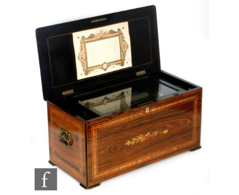 A musical box playing ten airs, eighteen key organ section, tune card, cylinder 23.5cm with crossbanded rosewood lid and the 