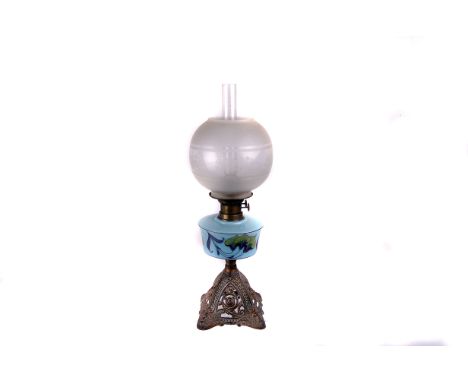 A Victorian oil lamp, having turquoise glass reservoir painted with lily style flowers 