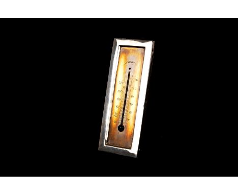 An Edward VII silver mounted desk thermometer, the silver brass gauge in rectangular silver frame with wooden back and stand 