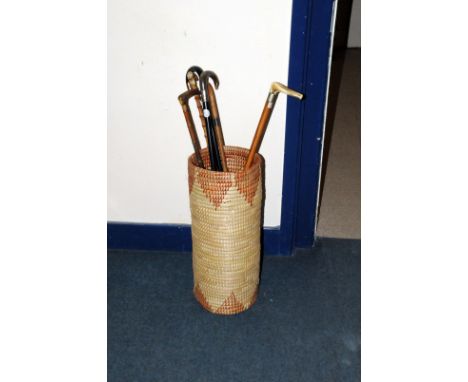 A collection of six George V and later walking sticks, one ebonised example with 9ct gold terminal, one walking stick with si