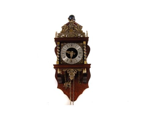 A modern wall clock, having wooden frame with applied brass ornaments including figure of atlas 