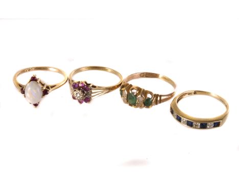 A group of four gem set rings, including a 9ct gold, sapphire and diamond half hoop eternity ring, an emerald and seed pearl 