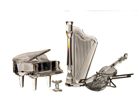 A collection of Swarovski crystal ornaments,  modelled as musical instruments, including a saxophone, a grand piano (AF), a h