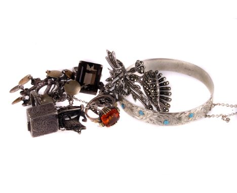 A small group of silver jewellery,  including a hinged bangle, a poison ring, a smoky quartz dress ring and other items 