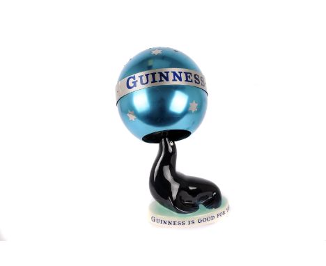 A Carltonware 'Guinness' Sea Lion lamp,  together with its metallic ball shade (2) 