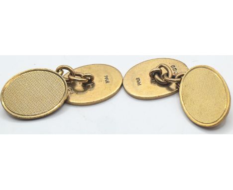 Pair of 9ct gold cufflinks, each with one oval plaque with engine-turned decoration, plaques measuring 18x13mm, stamped 9.375