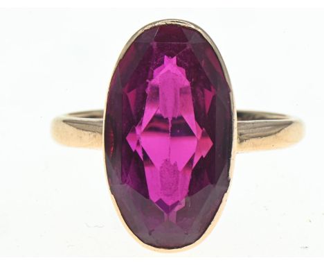 Yellow metal mounted oval-shaped synthetic ruby ring, faint marks to back of shank, tests positive for 18ct gold, size P, gro