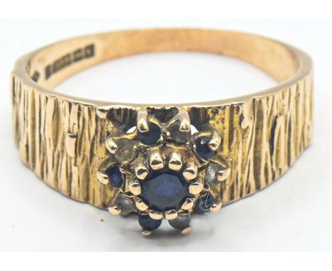9ct gold ring with bark style finish and central cluster with sapphire, size R, gross weight 3.39 grams