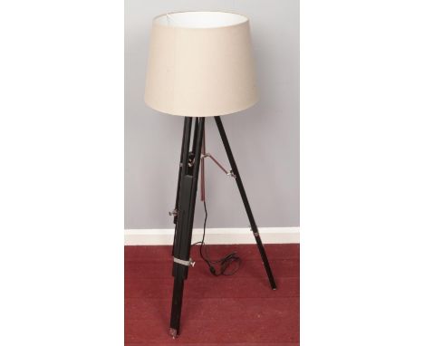 A tripod converted standard lamp with shade.  