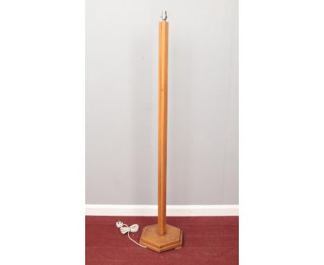 An Oak Art Deco floor lamp stand. Comprising of a hexagonal base. H: 148.5cm.  Condition good. No shade. In working order.