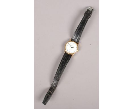 An Omega de Ville manual gold plated wristwatch with leather strap.  Winds but not running.
