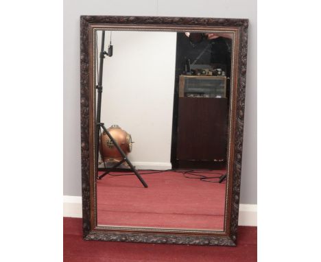 A carved wooden framed mirror. (86 x 60cm)  