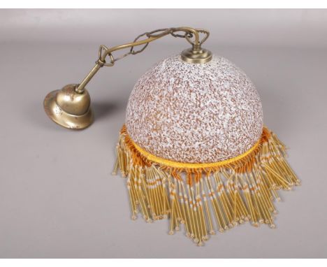 Opaque glass ceiling light with beaded hanging decoration.  Condition good. Some rusting on the metal top.