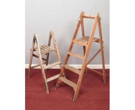 Two pairs of vintage wooden step ladders. H:126cm. H:96cm.  