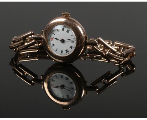 A ladies 9ct gold manual wristwatch. With 9ct gold expanding strap. 29.55g gross weight.  