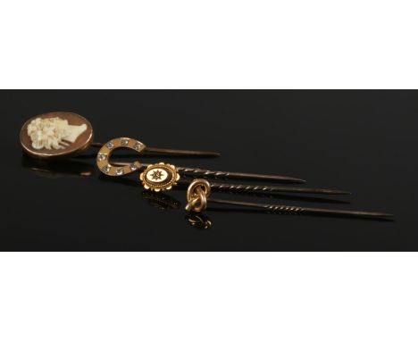 Four gold stick pins. Includes three 9ct gold examples and one 15ct gold example set with a single diamond.  